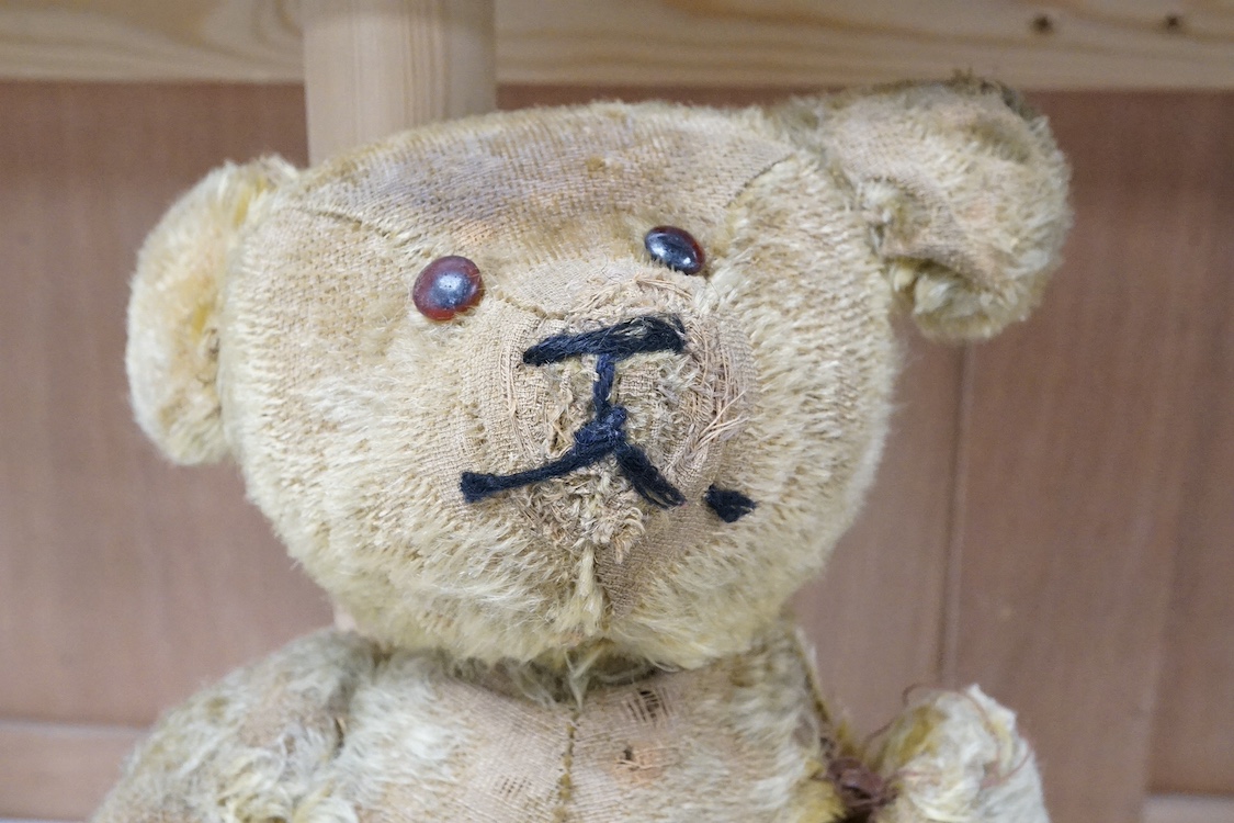An early 20th century blonde mohair Teddy bear, 45cm. Condition - poor